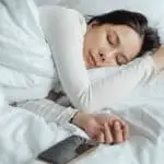 woman sleeping beside smartphone